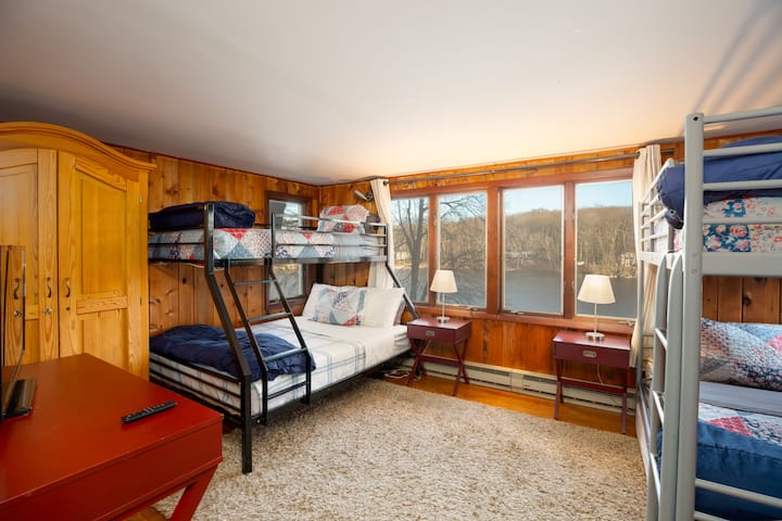 3rd bedroom is located at the basement level. To access this room you either walk through the basement or through an outside door, accessible via the patio. The basement has a low ceiling when you walk down the steps but then goes to full height. 