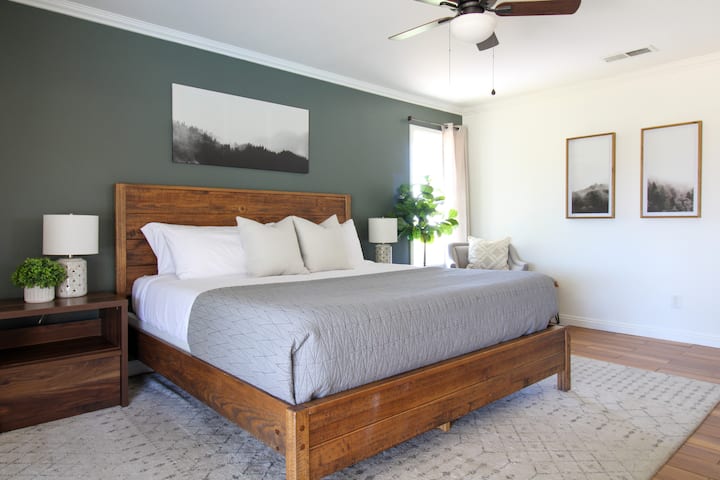 Primary bedroom with private bathroom and king bed. Direct access to pool and yard.