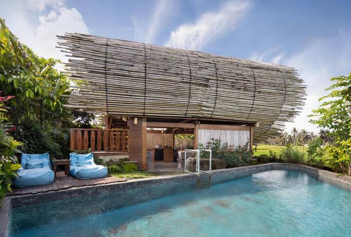 cylindrical villa surrounded by rice farms; kecamatan ubud, bali