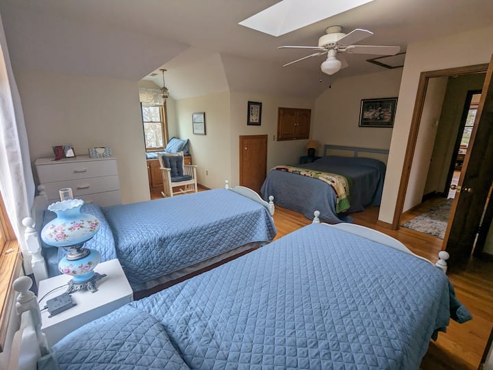 Upstairs bedroom, 2 twin. beds, 1 double bed, and window seat.
