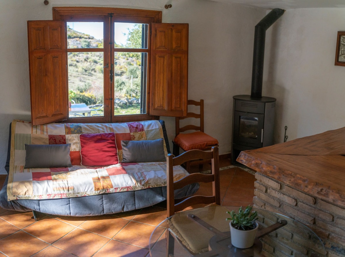 The Cortijillo bungalow has a kitchenette and a cozy living room with fireplace.