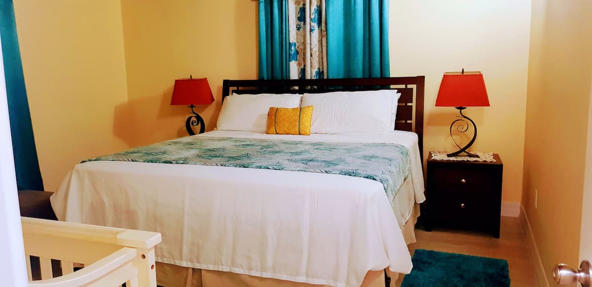 King bedroom with charming decor and soft bedside lighting