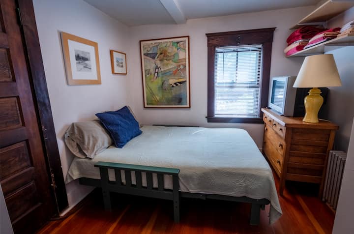 Futon sofa converts to a double bed depending on number of guests. There is not space for a bedside stand.