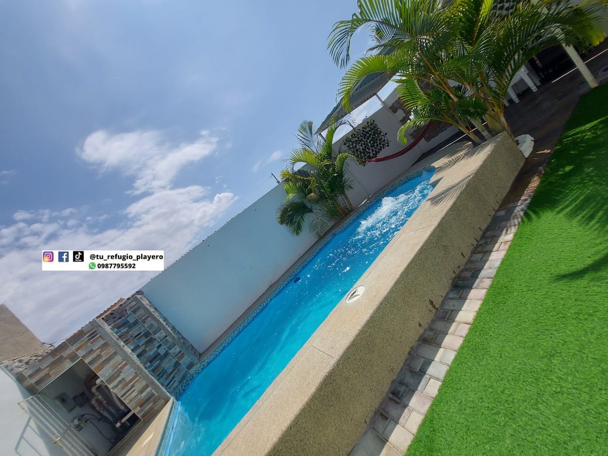 A private swimming pool is surrounded by palm trees, offering a serene atmosphere. The pool is integrated with a jacuzzi and features a light-colored stone border. A section of manicured grass is visible nearby, enhancing the outdoor space.
