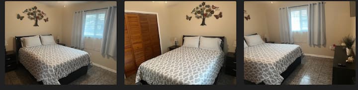 Click on the photo for an extended view. A queen size bed is provided with four pillows for your comfort. There is also a ceiling fan to keep you cool and a flat-screen TV mounted on the wall.