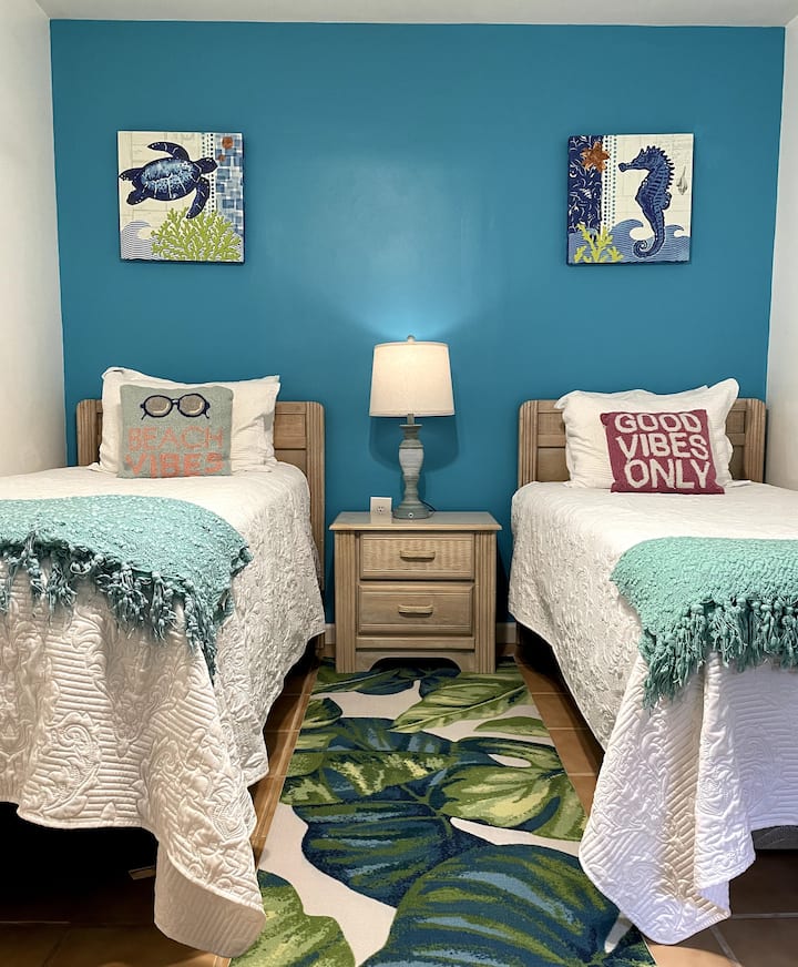 Good Vibes!  This special twin bedroom is lively and beachy and soo cozy.