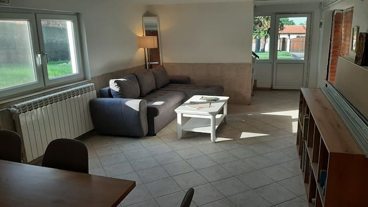 Escape to the inviting atmosphere of our open-plan living room and dining area. The sofa easily unfolds into a double bed, accommodating extra guests. Gather around the dining table, creating cherished moments with family and friends. #CozyLiving
