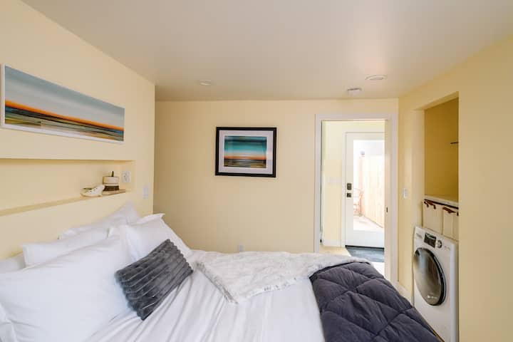 Close the pocket door to separate the living room/kitchen and bedroom for a bedroom retreat or leave it open as pictured here for a light and sunny room. Art by local Sacramento artist Micah Crandall Bear.