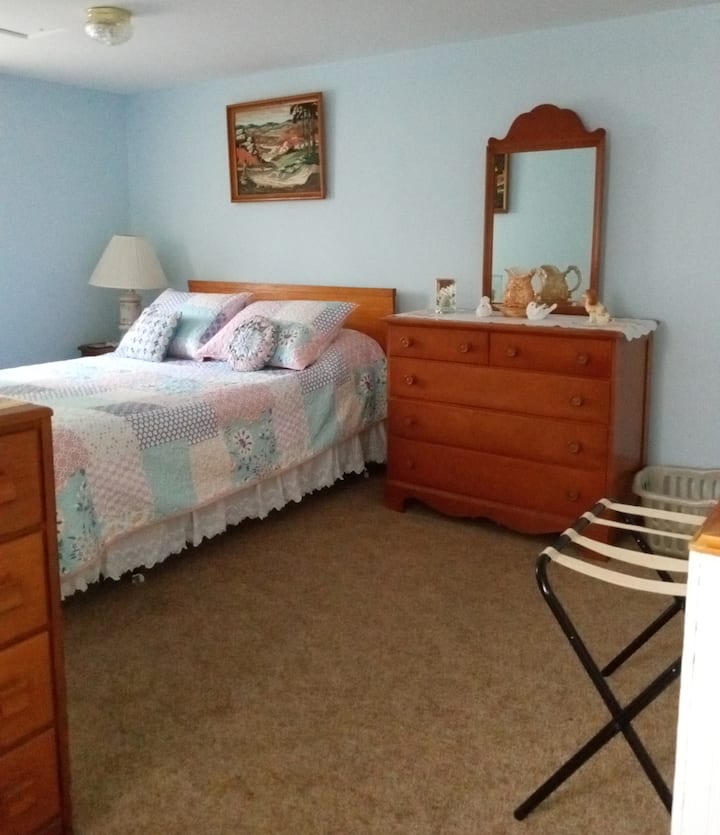 Full bed in small bedroom area. Curtains for privacy.