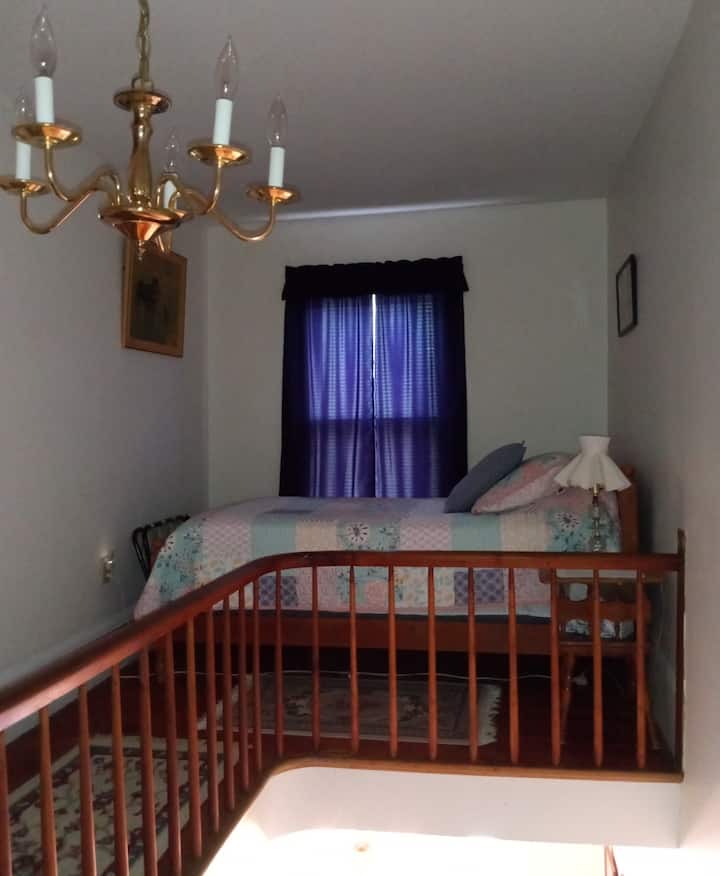 Twin bed in balcony area of main stairway