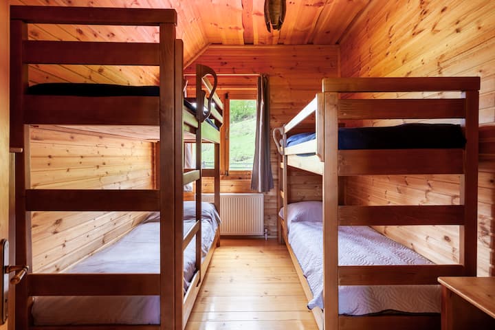 Bedroom with two bunk beds. Upper beds are for kids only, lower can be for adults too. 
