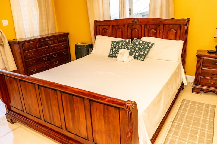 Experience the ultimate comfort and convenience in our master bedroom. Enjoy ample storage with our dresser drawers and a clothes closet, a nightstand with a lamp, and a portable AC to keep you cool and comfortable
