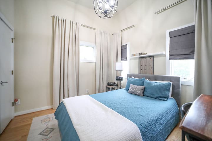 The guest bedroom features a queen sized bed and lots of light! The full size bathroom is just outside the door.