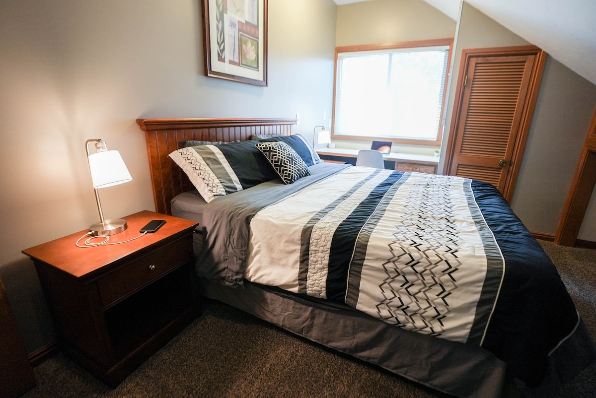 Westside bedroom has a king size bed and a desk to work from home. 