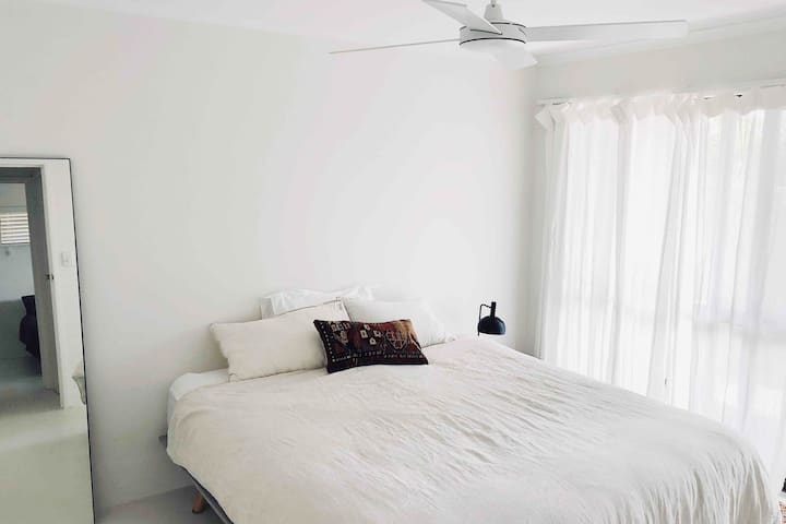 חדר שינה 2 עם דלת הזזה המובילה למרפסת וגינה פרטית. 