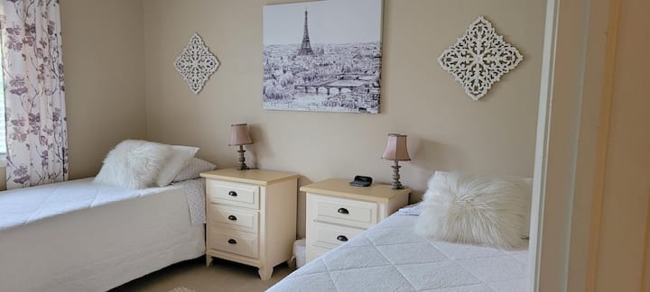 Third bedroom with two TwinXL Tempur Pedic adjustable beds.  Dresser and closet space available for guest use.   Bedside lamps and clock with phone charging pad.