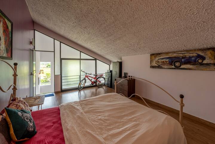 The attic bedroom is a true gem, with its whimsical decor and charming ambiance. The restored furniture adds a touch of nostalgia, while the cozy brass bed invites guests to unwind and indulge in a peaceful night's sleep.