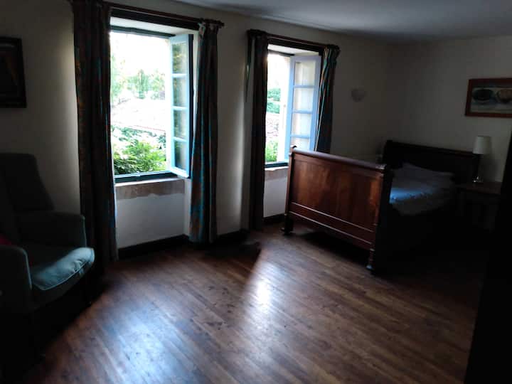 large upstairs room with two antique 'lit bateau' and views over the courtyard.