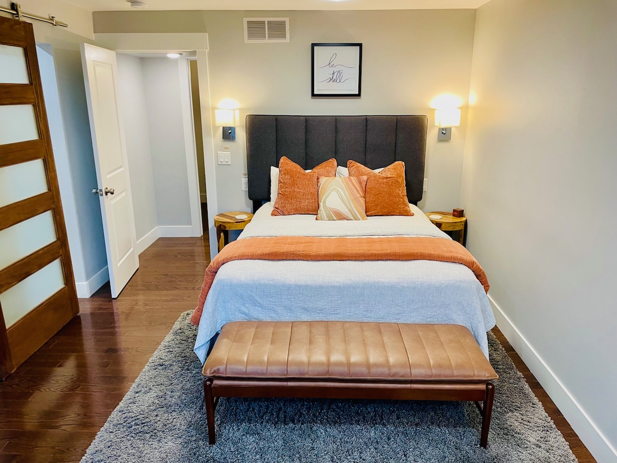 The main floor primary bedroom includes an ensuite luxury bathroom and also a spacious sitting/dressing area (see next photo). 