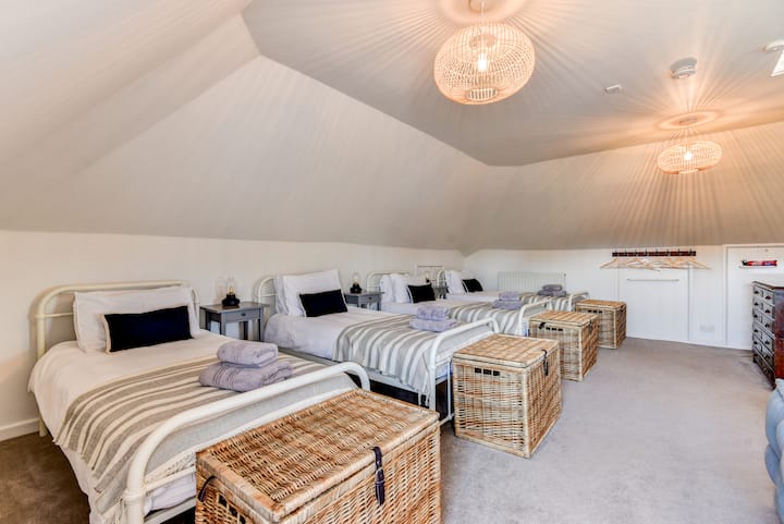 Attic room, four single beds with tv and soft sofas