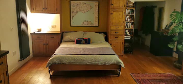 King-size bed and storage areas; bed can be folded up into wall cavity if required

(Electric fire under bookshelf if required)