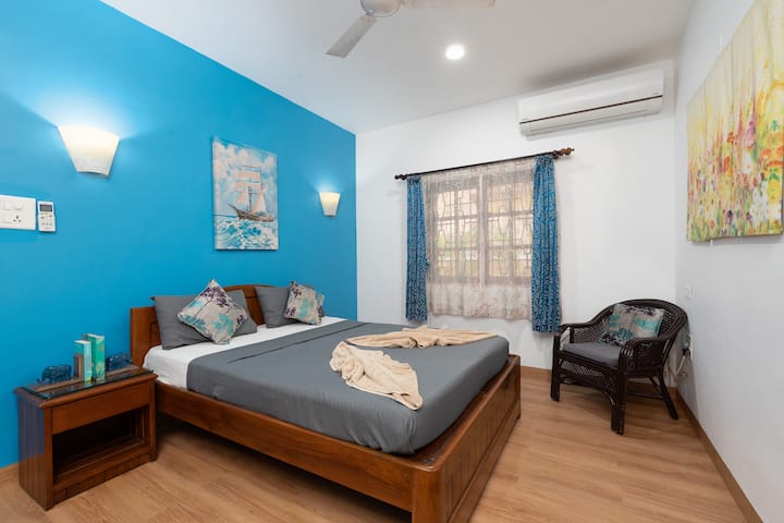 Blue master bedroom with en suite bathroom
