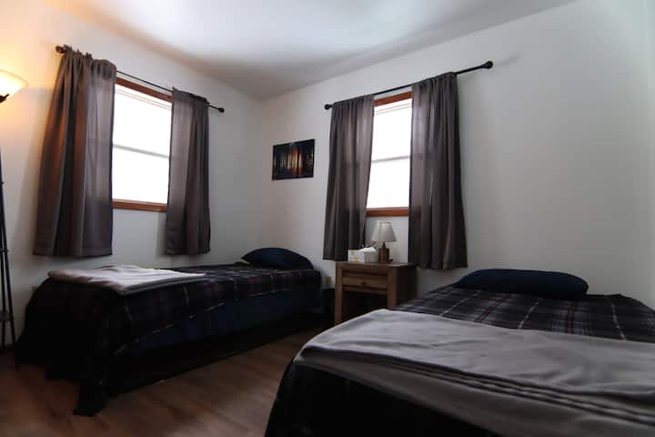 Third bedroom with two single beds on the lower level.