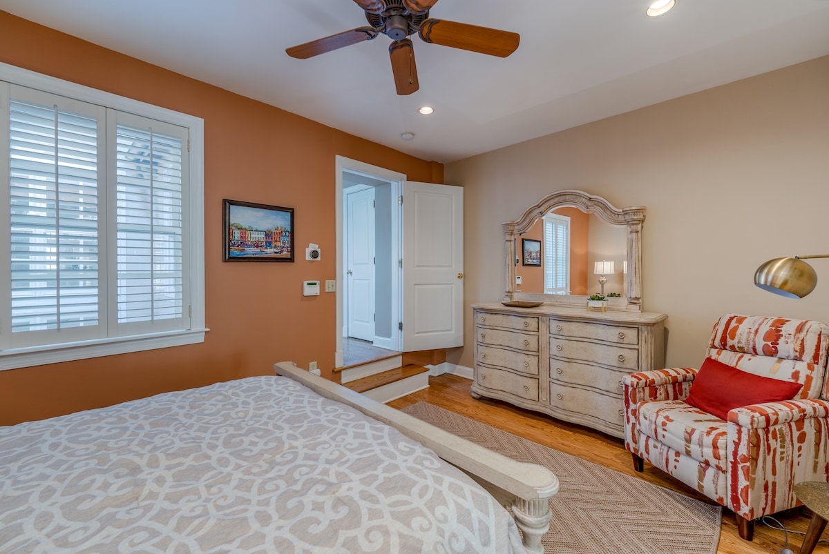 Primary Bedroom features relaxing, elegant furniture with a window overlooking the garden.