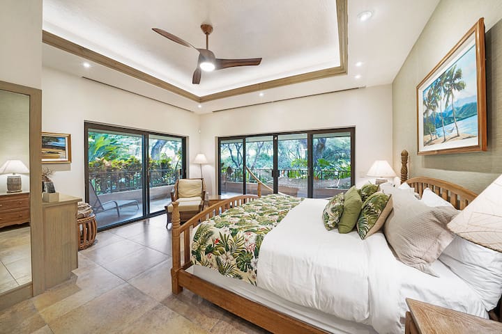 Unwind in this serene Maui bedroom retreat, where tropical linens, a spacious layout, and private lanai access invite you to relax and recharge in paradise.