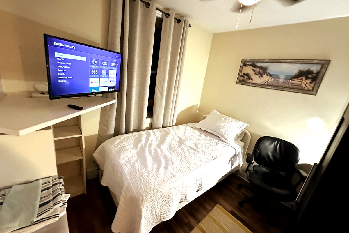 חדר שינה  עם שולחן עבודה, מיטה זוגית, שידה/ארון וטלוויזיה חכמה עם נטפליקס.