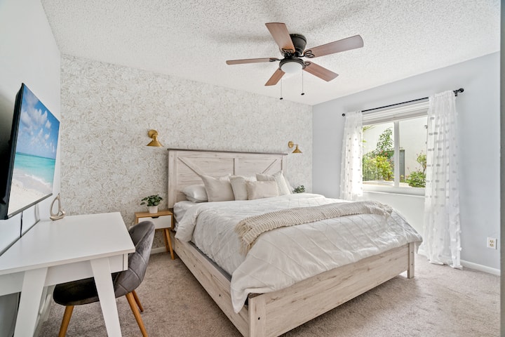 Bedroom 2: Brand new King size bed, new Smart TV, desk, tropical wallpaper, and dresser.