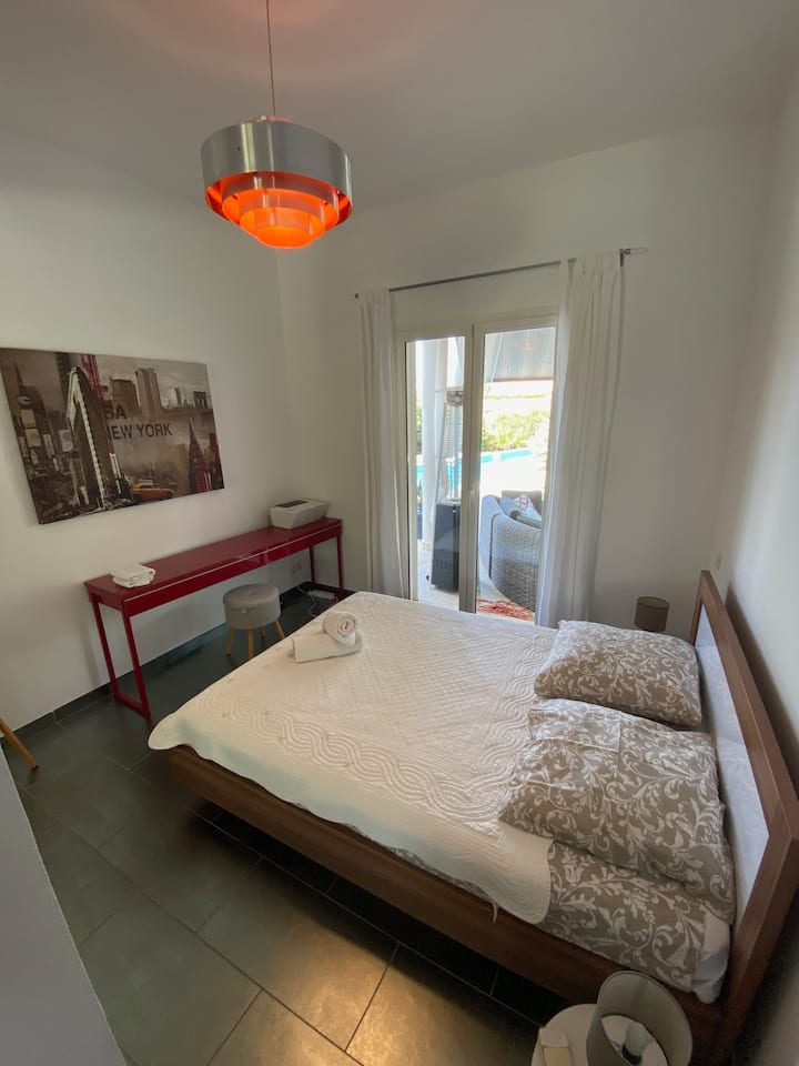 La habitación principal de la planta baja, que da al área de la piscina, está equipada con una cama doble de 140 cm de ancho.