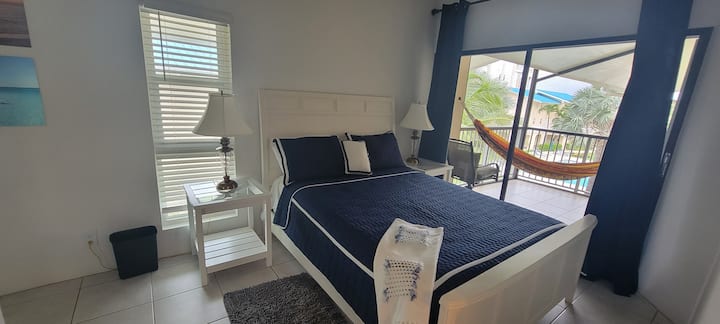 Bedroom 2 with a queen bed & direct access to upper balcony