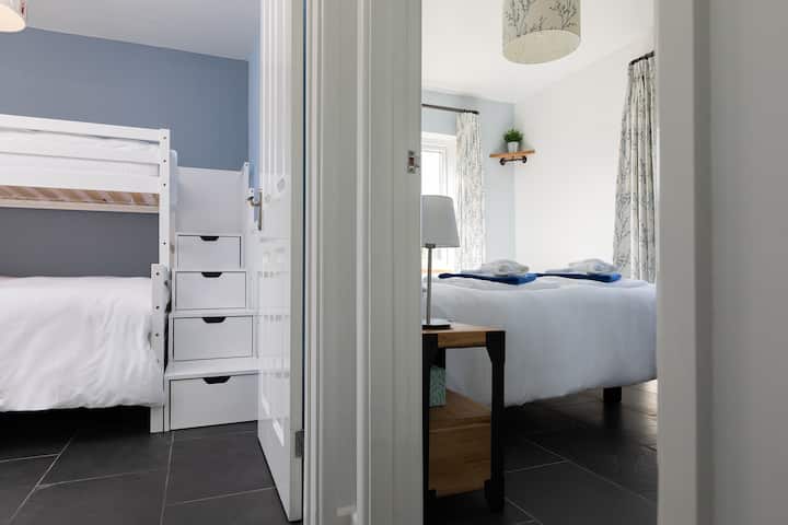 Bunk room is next to the second bedroom at the end of the corridor. 

Ty'r Felin is a bungalow, so once inside the main area, all rooms are on the same level.