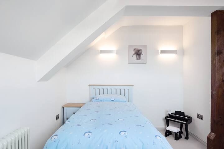 El acogedor dormitorio individual en el piso superior es sencillo y funcional