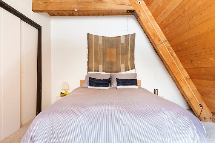 Private downstairs bedroom with ceiling fan and large closet.