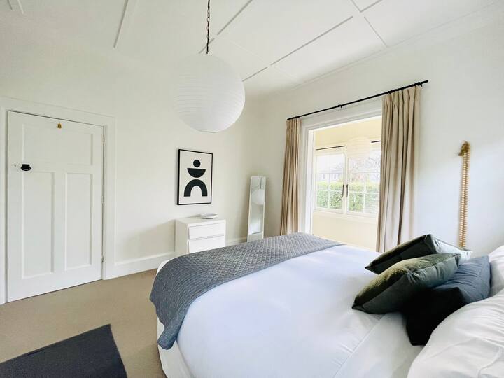 Master Bedroom with wardrobe and sunroom - Super King Bed wth luxury Linen and featuring  Bauhaus art.