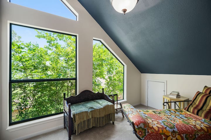 upstairs loft boasts an amazing tree top view of the lake.
