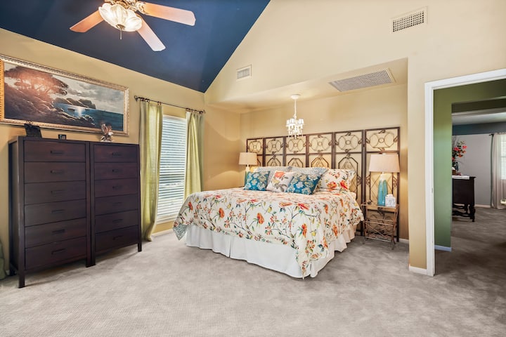 oversized primary accommodations with ensuite bathroom, closet & private loft seating area with a view of the lake.  