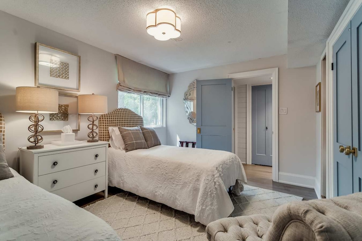 main floor guest room with 2 twin beds and bath off hallway