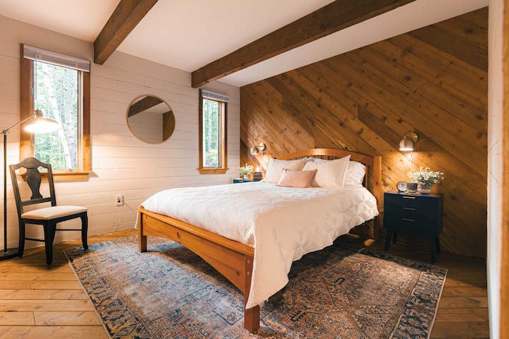 Primary bedroom with queen bed, large closet, and two nightstands.