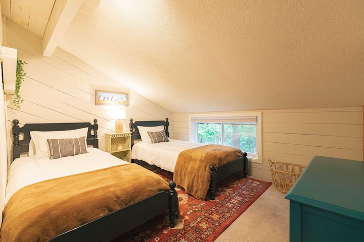 2nd FL - The Bear Room with twin beds, a cabinet, shelving, and hooks. 