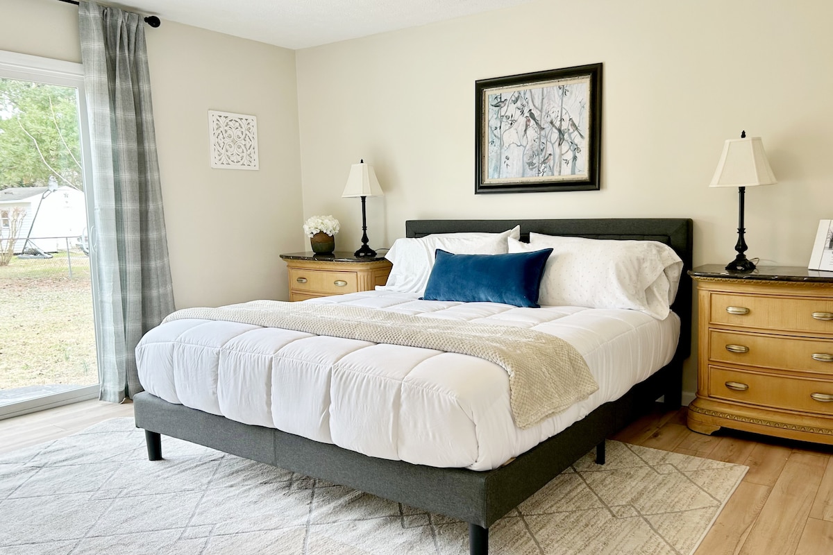 ห้องนอนเตียงคิงไซส์พร้อมทางเข้าสวนหลังบ้าน