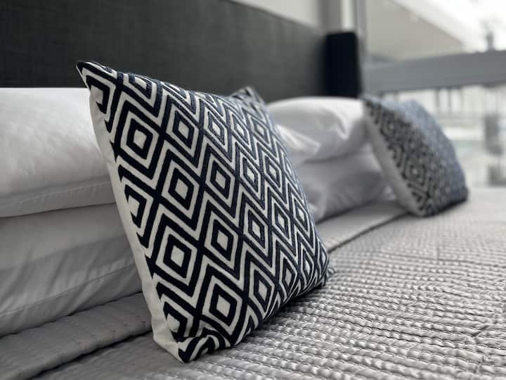 The comfort of our second bedroom, where a king-sized bed invites you to unwind with a good book and a glass of wine. Your own private SMART TV in the room ensures relaxation on your terms, captivating our short-term rental guests. ONLINE REVIEWS !