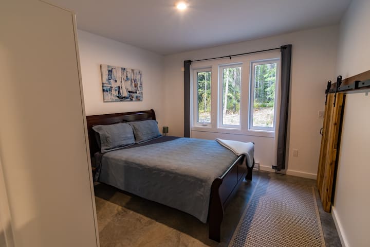 Our second bedroom has a queen bed and wardrobe for storage.  This room offers views of the mountains and the forest.  There is a small bedroom under the stairs for children.