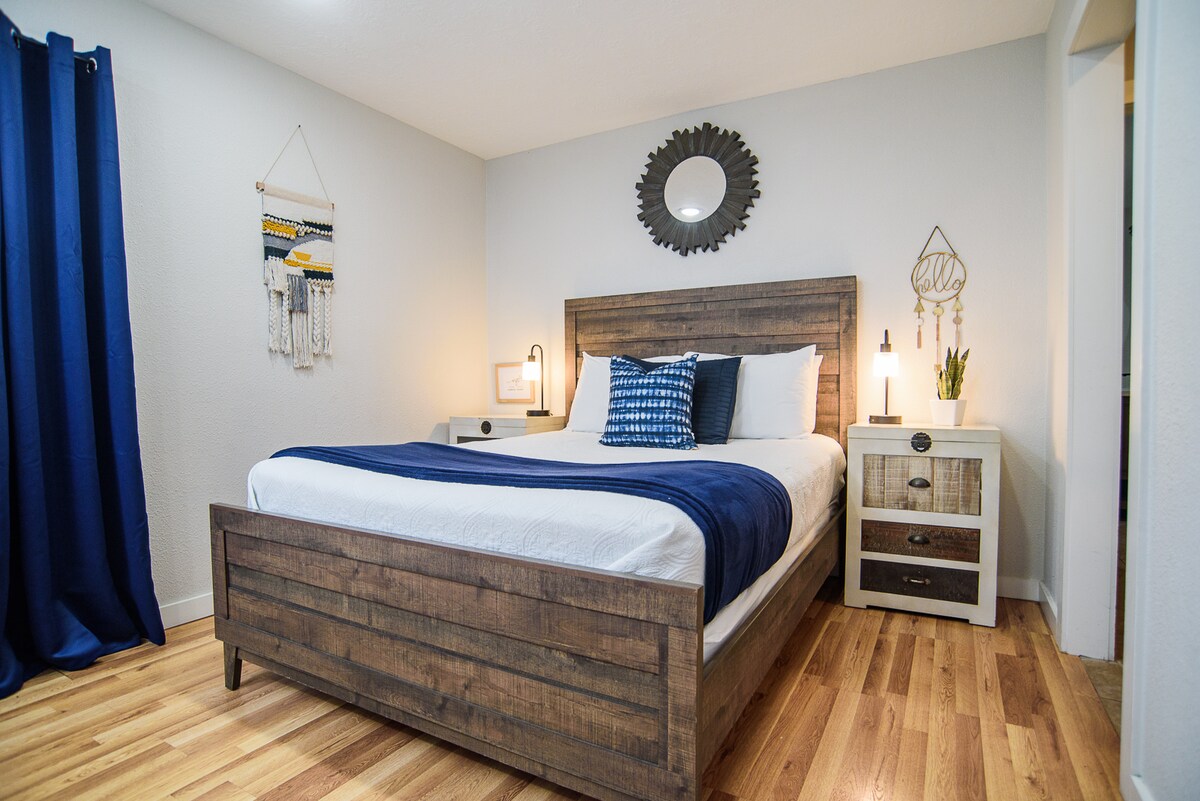 Queen Size Bed Hall way to adjoined bathroom and  closet area.