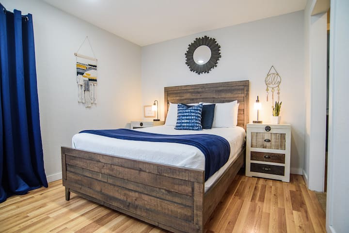 Queen Size Bed Hall way to adjoined bathroom and  closet area.