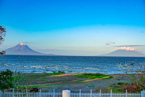 House in front of the lake and overlooking volcanoes