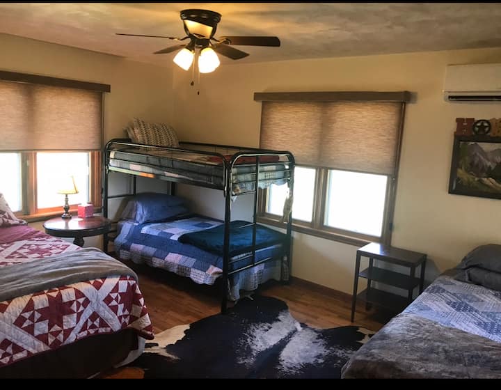 Bedroom 1 on main floor. One queen bed, 1 twin bed, and one bunk bed (twin size).