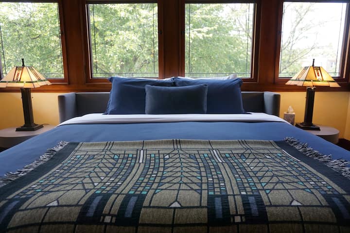 The master bedroom designed for Mr. Emil Bach is centered at the front of the home on the 2nd floor, featuring a King size bed framed by stained glass windows. Abundant natural light and room darkening shades complete this sanctuary.  